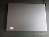 a laptop that is sitting on a table with a sticker on it