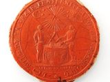 an image of a red coin with a picture of a man and a woman on it