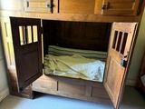 a dog bed in the middle of a wooden bunk bed