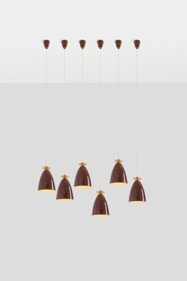 a set of six brown and gold pendant lights hanging from a ceiling