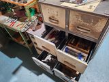 many drawers that have tools in them in a room