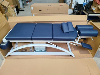 an image of a blue and white examination table in a warehouse