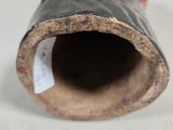 a close up of a pipe with a tag on it