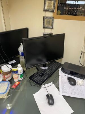 a desk with two monitors, a keyboard, and a mouse on it