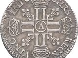 a close up of a coin with a cross on it