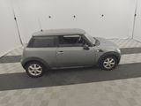 a small gray car parked in a garage