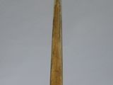 a tall wooden object on a metal stand on a white surface