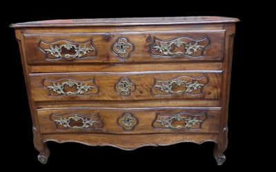 an old wooden chest of drawers with ornate carvings on the drawers