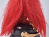 a red wig sitting on top of a black helmet