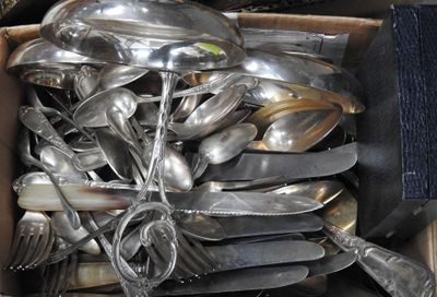 a box full of silver spoons and forks in it
