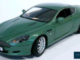 a green model of a car on a white surface