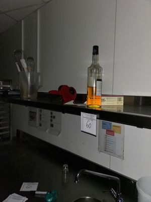 a bottle of alcohol sitting on a counter in a kitchen