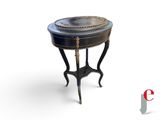 a small table with a black top and gold trimming