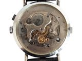 a close up of a watch on a white background
