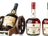 three bottles of courvoisir and a bottle of courvoisir on a wooden stand