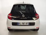 a picture of a small white car parked in a garage