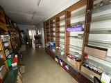 a long room with many shelves and boxes on it