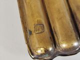 a close up of a metal object on a white surface