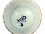 a blue and white bowl with a picture of a cat on it