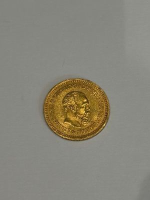 an image of a gold coin sitting on top of a white surface