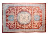 a red and blue rug with a medallion design on it