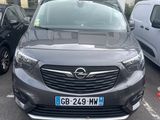the front of a grey opel parked in a parking lot next to other cars