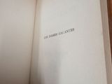 an open book sitting on top of a wooden table next to a chair