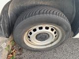 a tire that is sitting on the side of the road