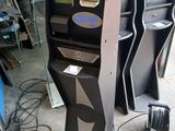 three black and silver electronic gaming machines in a room