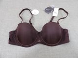 brown bralette on a bed with a price tag on it