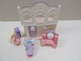 a small doll house with furniture and accessories on the table
