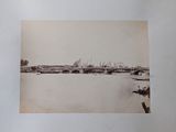 a black and white photo of a bridge over a body of water