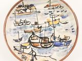 a plate with a painting of boats on it