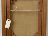 an old picture frame with a tag attached to it