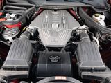 the engine compartment of a red sports car with its hood open