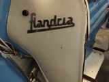 a blue and white scooter parked in a garage
