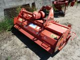 an image of a red machine that is sitting in the dirt