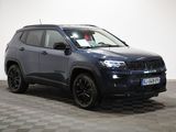 a grey jeep compass parked on a checkered tile floor