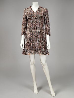 a mannequin dress with fringes and buttons on the shoulders