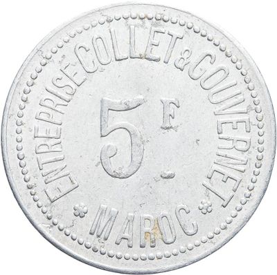 a close up of a coin with the number 5 on it