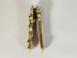 pair of antique brass clothes pegs on a white background