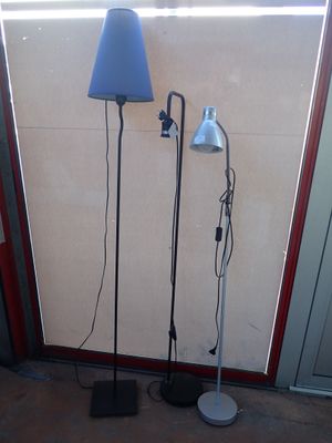 two lamps that are standing next to each other on the floor