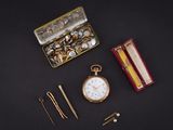 a box with a pocket watch, a pair of scissors, and a pair of pins