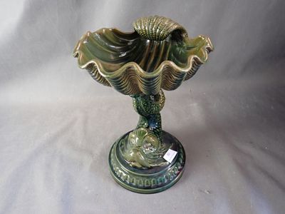 a green vase that is sitting on a white table