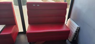two red chairs sitting next to each other in a room