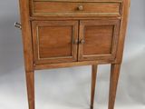 a small wooden table with a marble top on it