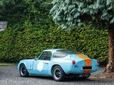an image of a blue sports car parked in front of a tree