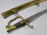two old swords are sitting on a white surface