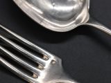 a fork and a spoon on a black table
