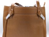 an image of a brown purse with a white tag on it